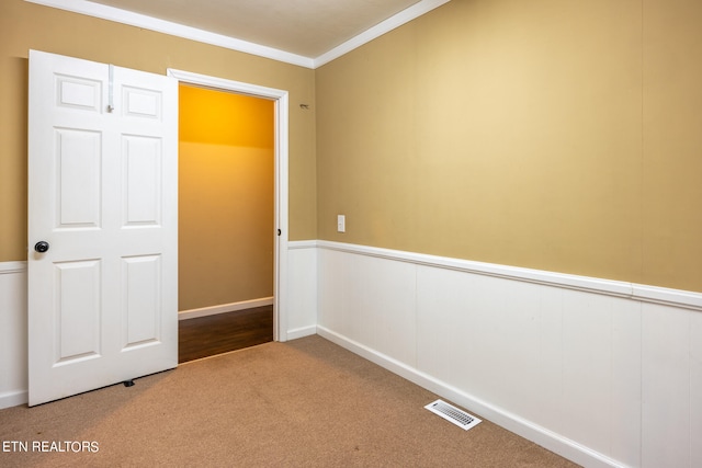 unfurnished bedroom with carpet and crown molding