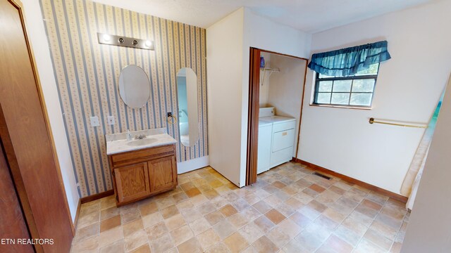 bathroom featuring separate washer and dryer and vanity