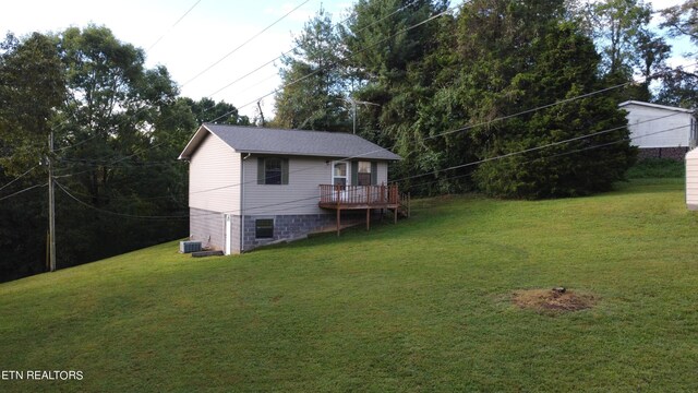 view of yard with a deck and central air condition unit