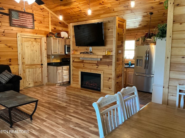 living room with wood walls, ceiling fan, wooden ceiling, hardwood / wood-style floors, and vaulted ceiling