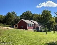 view of property exterior with a lawn