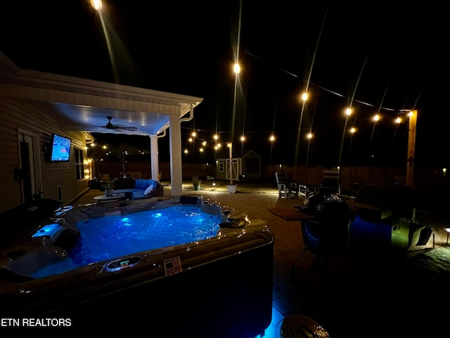 view of pool with ceiling fan, a pergola, and an outdoor hot tub