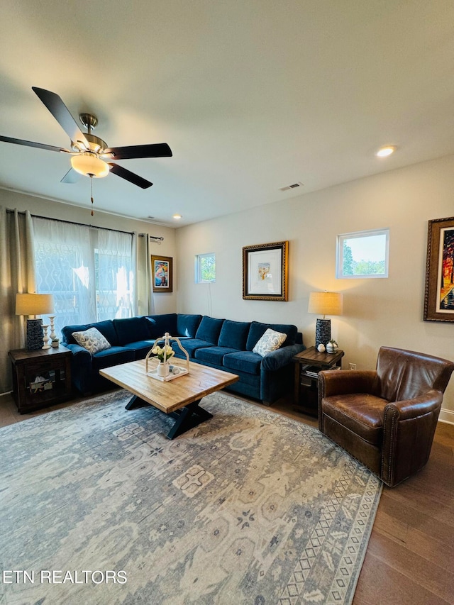 living room featuring hardwood / wood-style flooring and ceiling fan