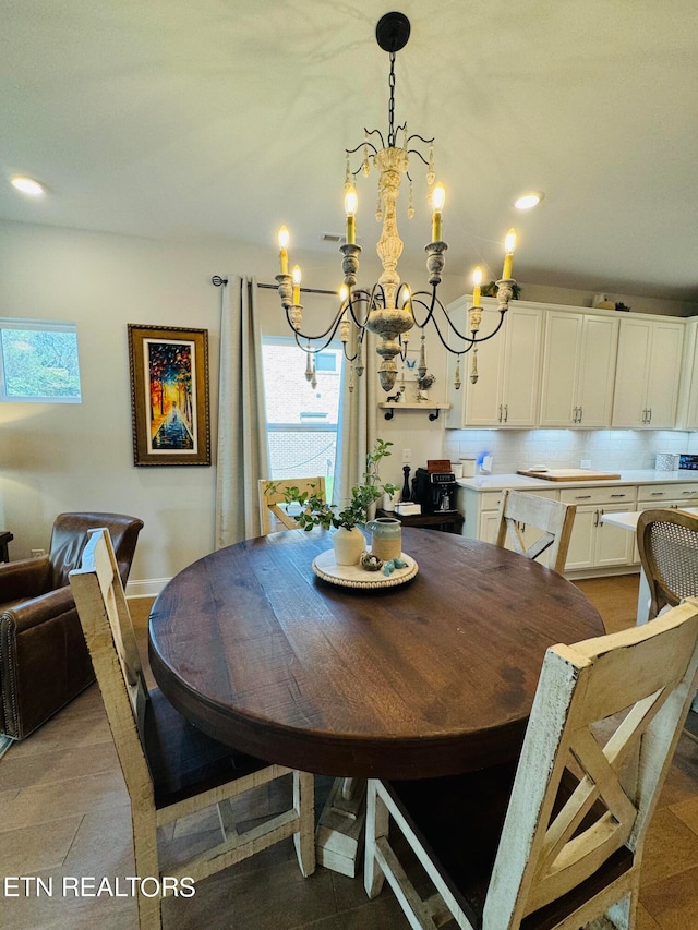 dining room with light tile patterned flooring and an inviting chandelier