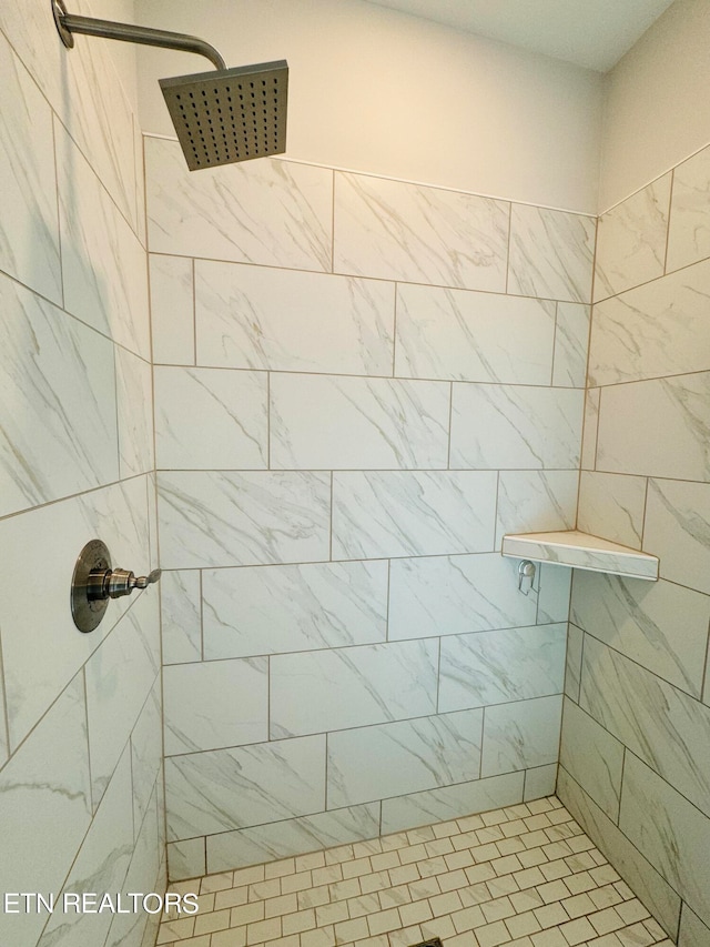 bathroom with a tile shower