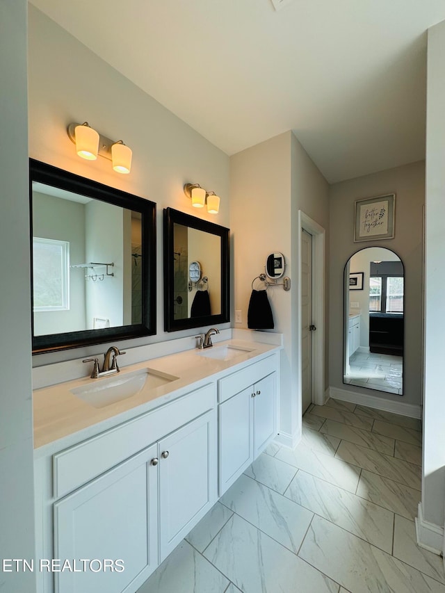 bathroom with plenty of natural light and vanity