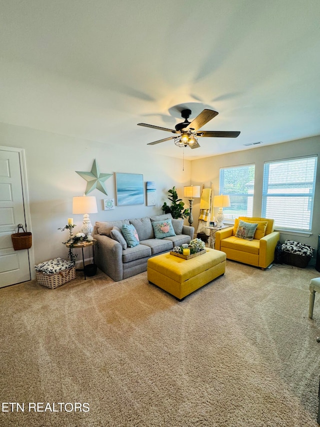 carpeted living room featuring ceiling fan