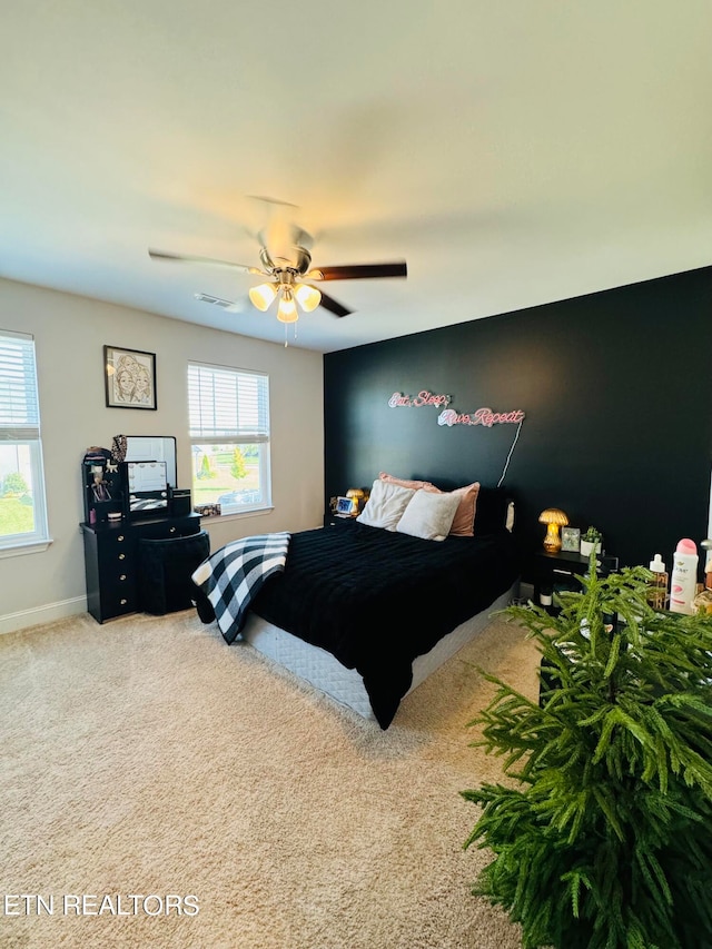 bedroom with ceiling fan and carpet floors