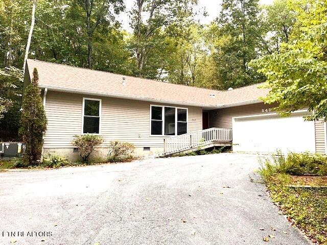 ranch-style house with driveway, crawl space, and an attached garage