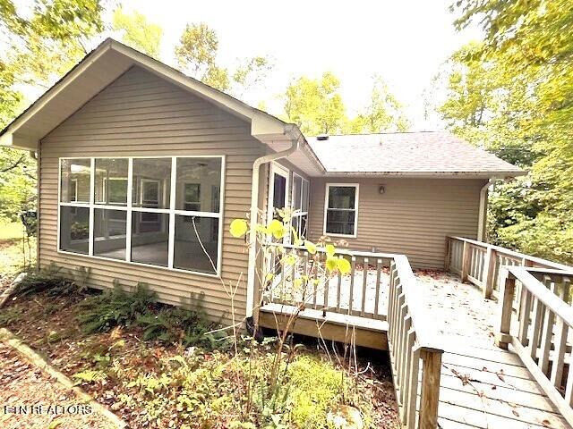 rear view of house with a wooden deck