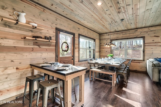 dining room featuring wood ceiling, wooden walls, and dark hardwood / wood-style floors