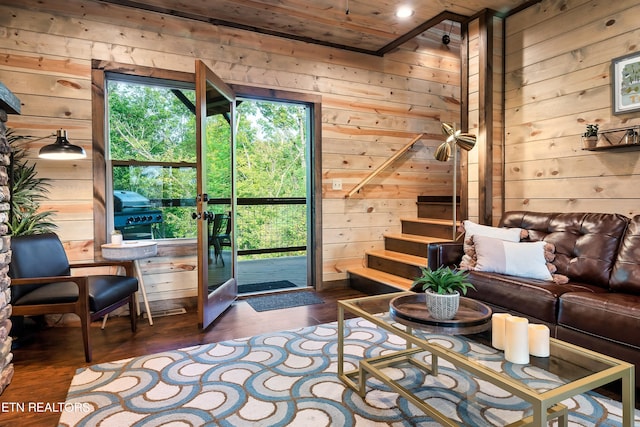 living room with wooden ceiling, dark hardwood / wood-style flooring, and wood walls