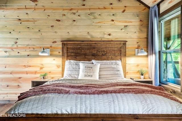 unfurnished bedroom featuring wood walls and hardwood / wood-style flooring