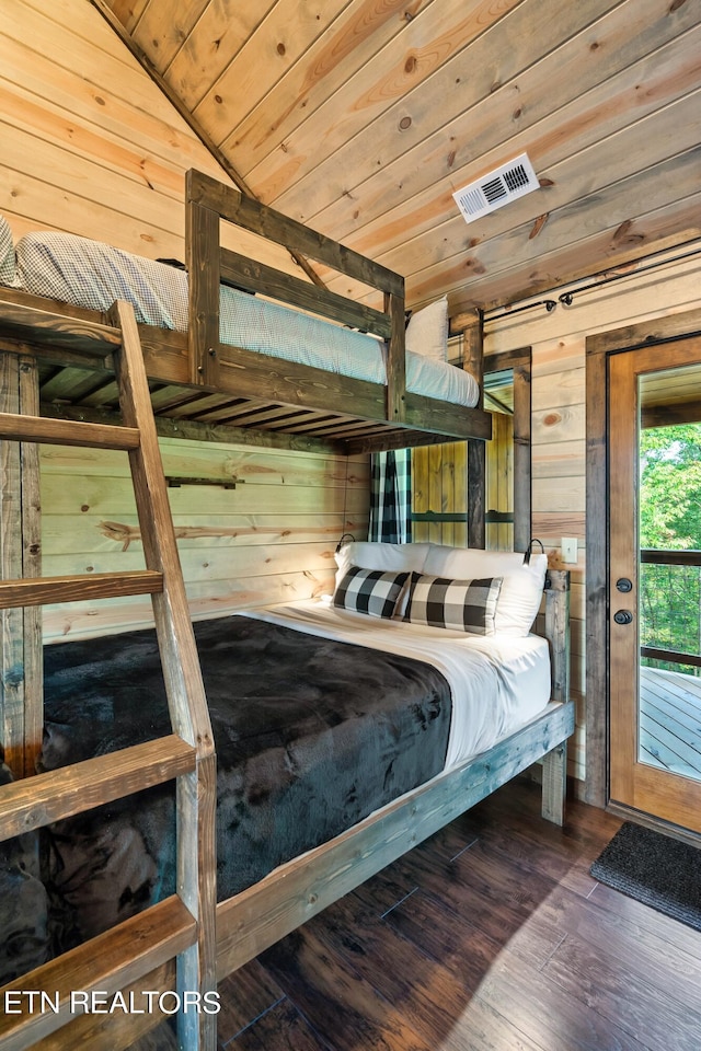 bedroom featuring wooden ceiling, vaulted ceiling, wood walls, and dark hardwood / wood-style floors