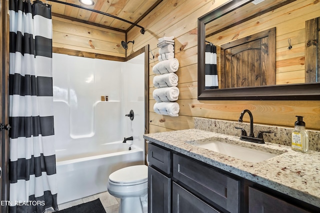 full bathroom featuring vanity, toilet, shower / tub combo with curtain, and wooden walls