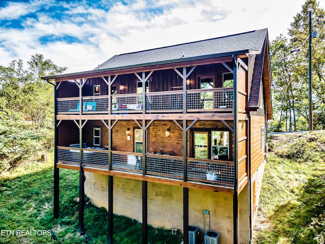 back of property featuring a balcony