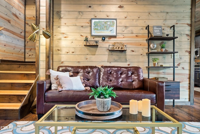 living room with wood-type flooring and wood walls