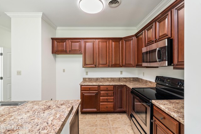 kitchen with light tile patterned floors, light stone counters, stainless steel appliances, and crown molding