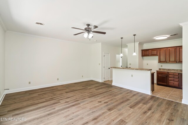 kitchen featuring hardwood / wood-style floors, ceiling fan, hanging light fixtures, and crown molding