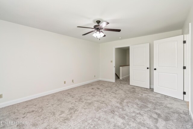 unfurnished bedroom featuring light carpet and ceiling fan