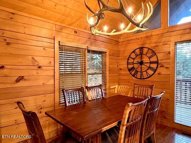 dining area featuring wood walls