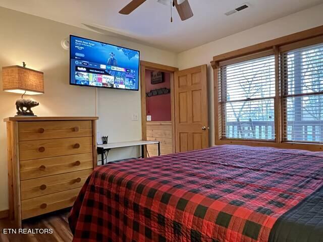 bedroom with ceiling fan and hardwood / wood-style flooring