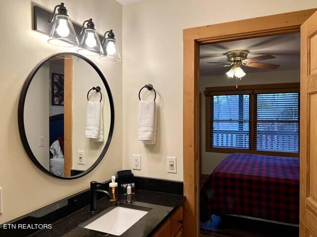 bathroom with ceiling fan and vanity