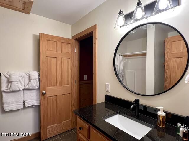 bathroom featuring tile patterned flooring and vanity