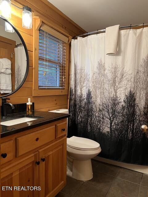 bathroom with tile patterned flooring, vanity, and toilet