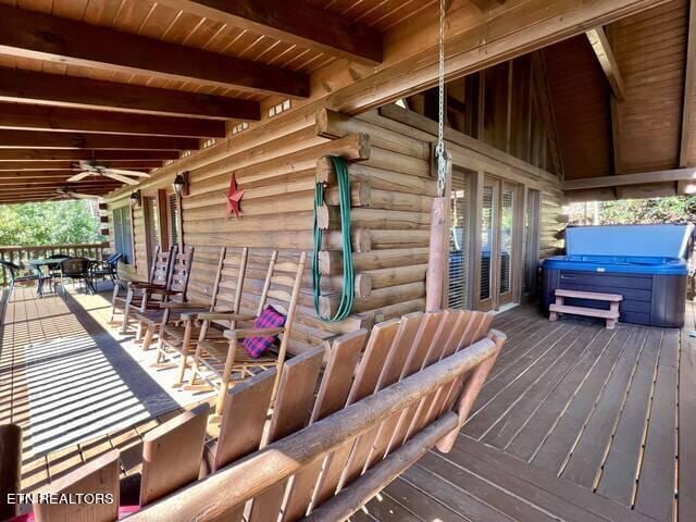 wooden deck with a hot tub