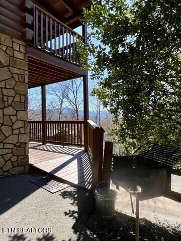 view of side of property featuring a wooden deck