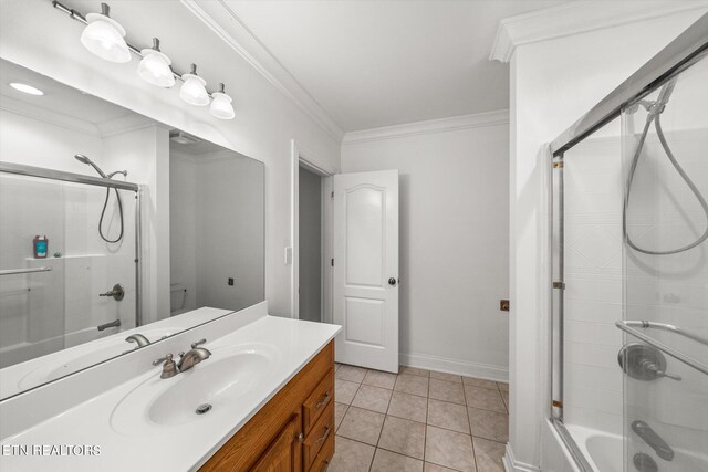 bathroom with crown molding, vanity, and tile patterned floors