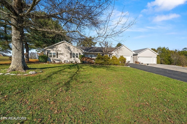 ranch-style home featuring a front lawn and a garage