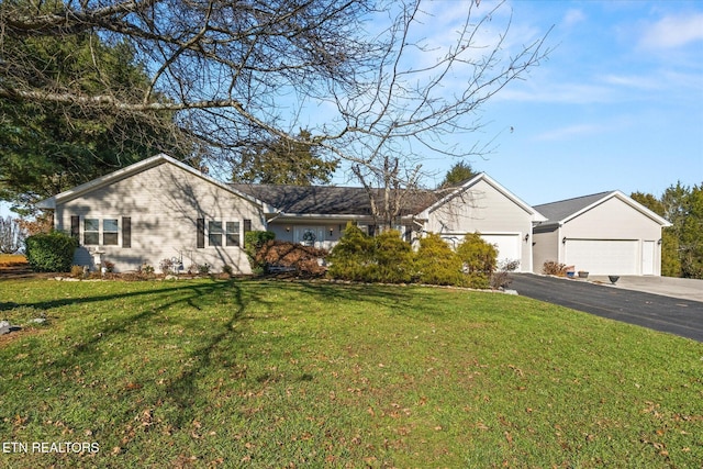 ranch-style house featuring a front yard and a garage