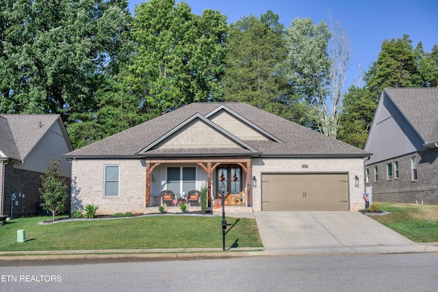 view of front of property with a garage and a front lawn