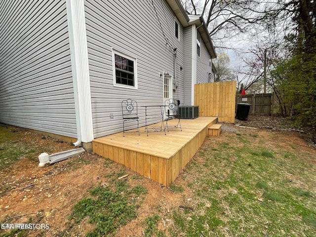 wooden deck featuring cooling unit and a lawn