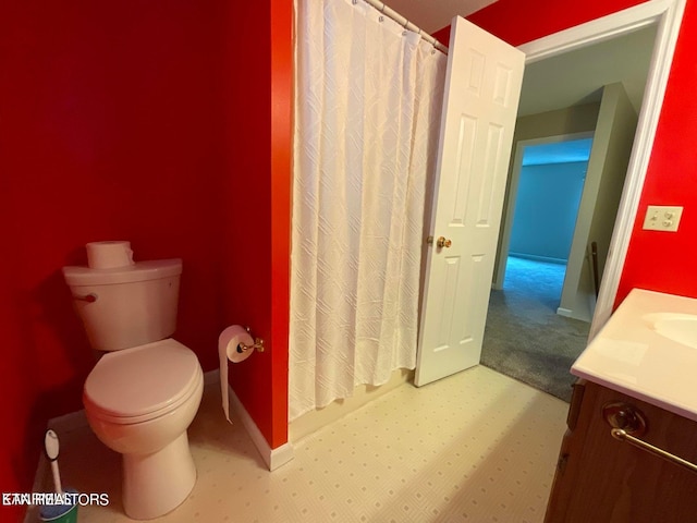 bathroom featuring vanity, toilet, and a shower with shower curtain