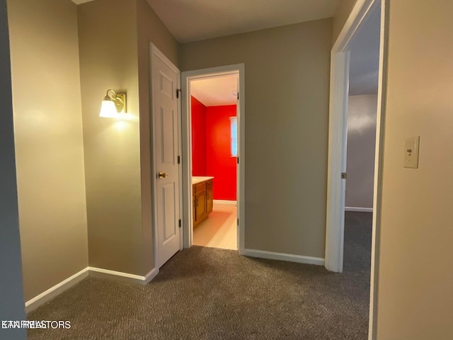 hallway featuring dark carpet