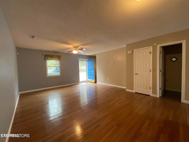 unfurnished room with a textured ceiling, ceiling fan, and dark hardwood / wood-style floors