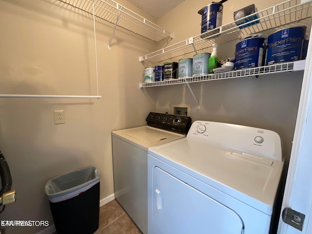 clothes washing area featuring separate washer and dryer and tile patterned floors