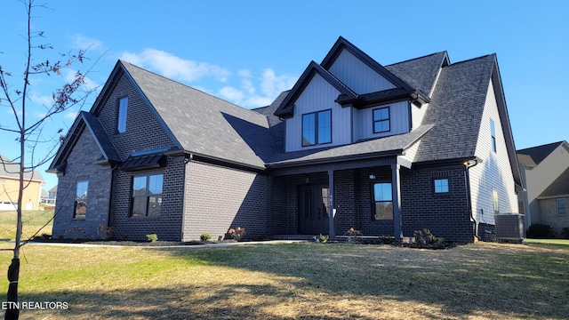 view of front of home featuring central air condition unit and a front yard