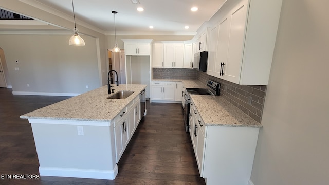 kitchen with sink, white cabinetry, a kitchen island with sink, and appliances with stainless steel finishes