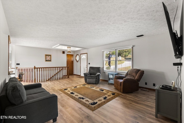 living room featuring a textured ceiling and hardwood / wood-style flooring