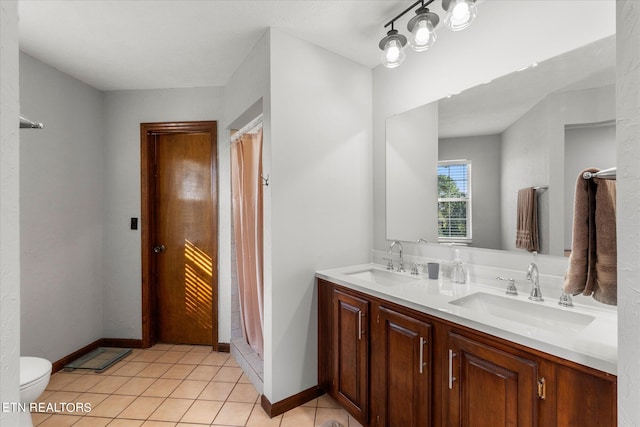 bathroom featuring vanity, toilet, and tile patterned flooring