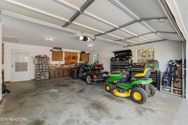 garage featuring a garage door opener and a workshop area