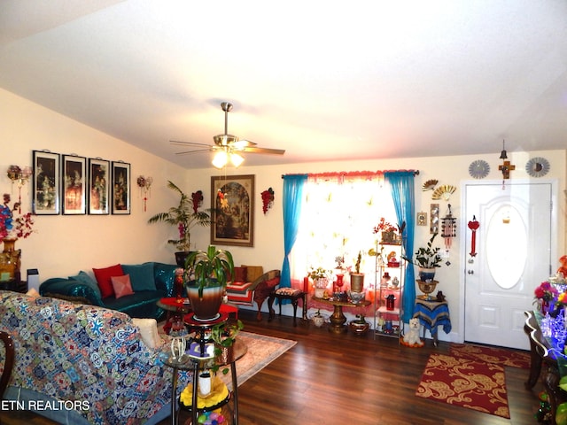 living room featuring lofted ceiling, ceiling fan, and dark hardwood / wood-style floors