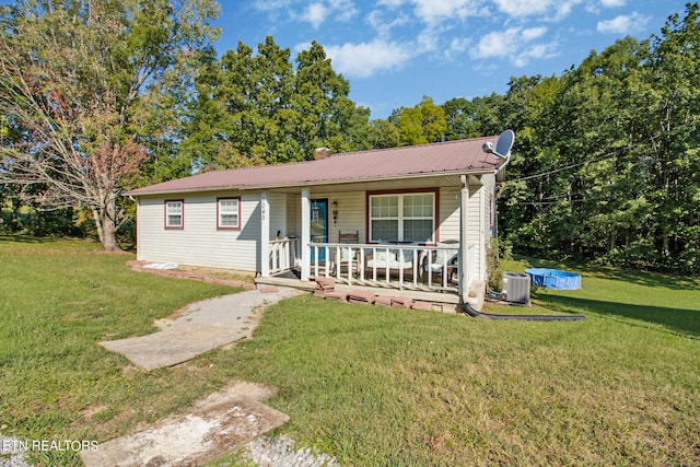 view of front of house featuring central air condition unit, a front yard, and a porch