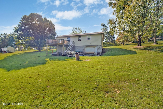 view of yard featuring a wooden deck and a garage