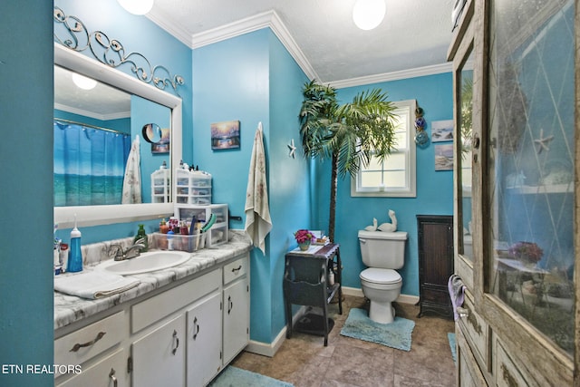 bathroom featuring crown molding, vanity, toilet, and a textured ceiling