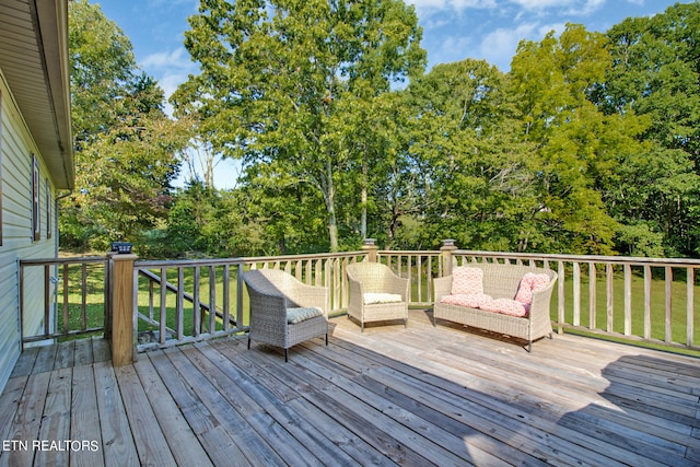 wooden deck featuring a lawn